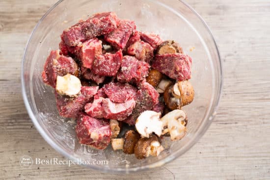 Cubes of steak and mushrooms in bowl