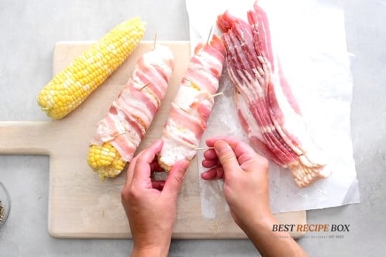 Securing the bacon wrapped corn with toothpicks