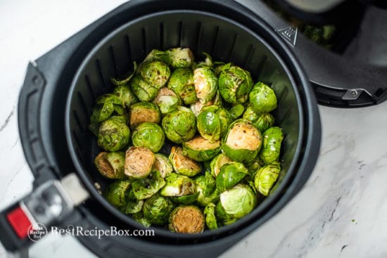 uncooked Brussels sprouts in air fryer basket
