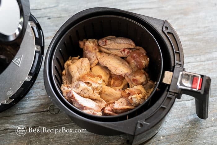 Uncooked wings in air fryer basket