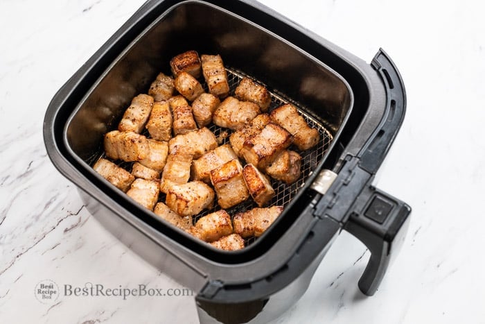 cut and cooked pork cubes in the air fryer basket
