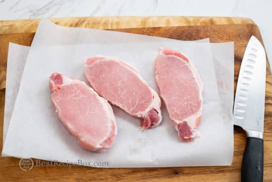 Pork chops on a cutting board 