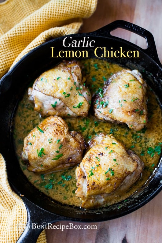 Baked Garlic Chicken Thighs Recipe in Creamy Garlic Lemon Sauce in a cast iron skillet