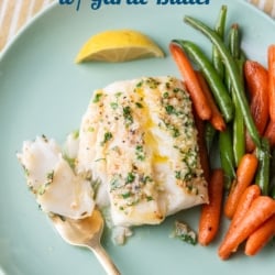 baked cod with vegetables on plate