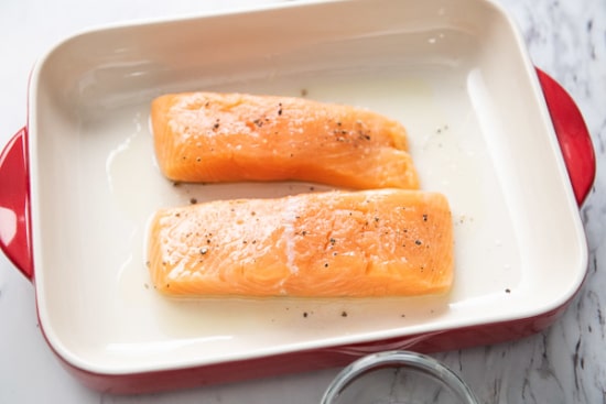 Raw salmon filet in baking dish