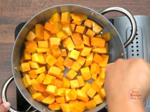 Stirring butternut squash in a pot