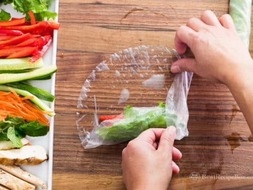 layering vegetables and chicken for summer rolls