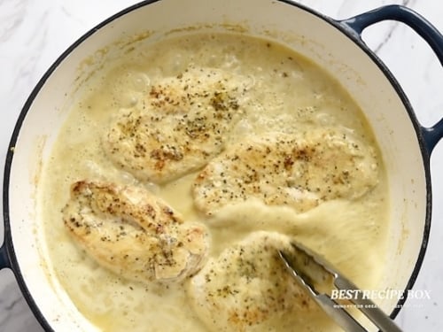 adding chicken to sauce