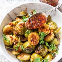 adding spoonful of chili crisp brussels sprouts