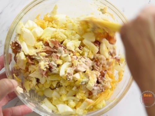 Stirring in the egg salad ingredients