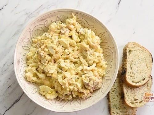 Cowboy egg salad in a bowl with toasts on the side