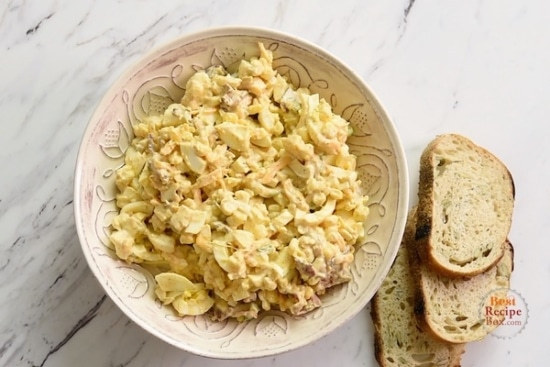 Cowboy egg salad in a bowl with toasts on the side