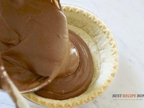 Pouring chocolate into pie crust