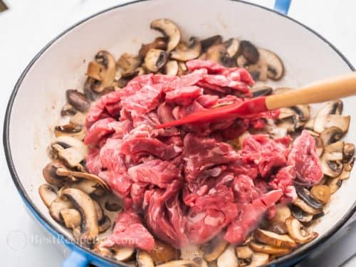 Beef and mushrooms browning in a pan