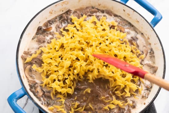 Broth and noodles added to beef and mushrooms