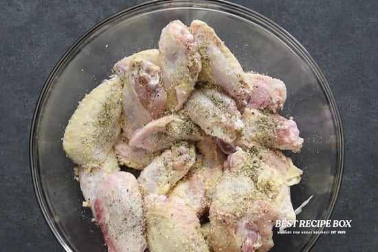 Seasoned raw chicken wings in a bowl