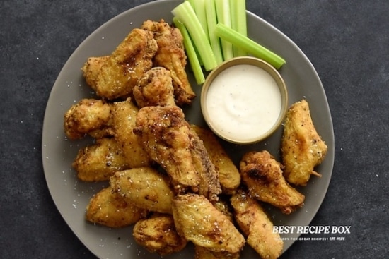 Chicken wings on plate with ranch and celery