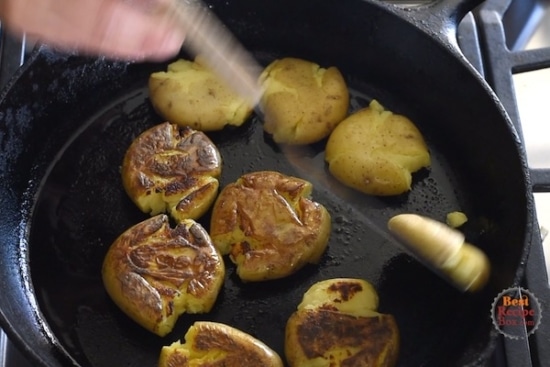 Flipping the crisped potato over in skillet