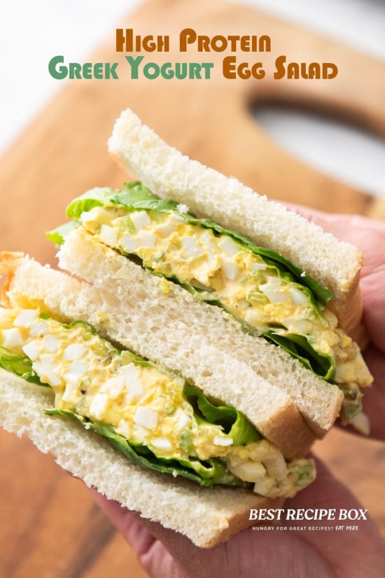 holding greek yogurt egg salad sandwich