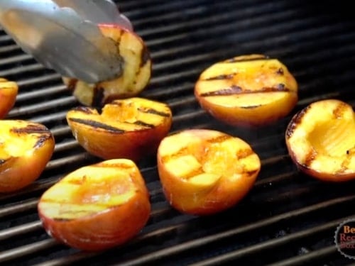 Removing peaches from the grill with tongs