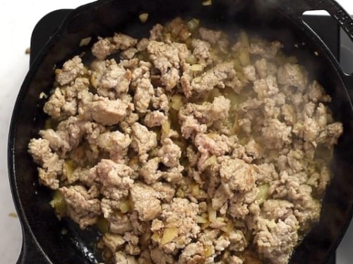 Cooked ground turkey with the onions and garlic in a skillet