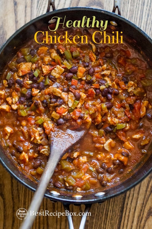 Healthy chicken chili recipe and such an easy chicken chili in a cooking pan with a wooden spatula
