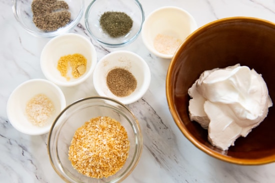 Spices and sour cream in bowls