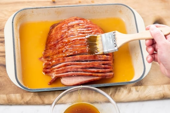 Brushing ham with glaze