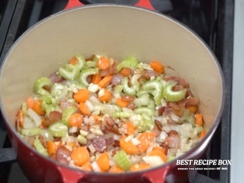 Cooking aromatics in pot with bacon