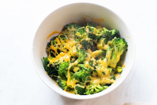Microwaved broccoli with cheese melted on top