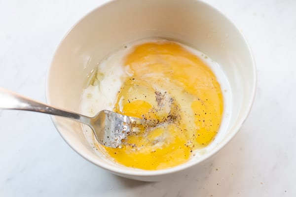 Eggs and milk beaten together in a microwave safe bowl