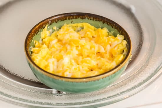 Cheese melted on top of scrambled eggs in microwave