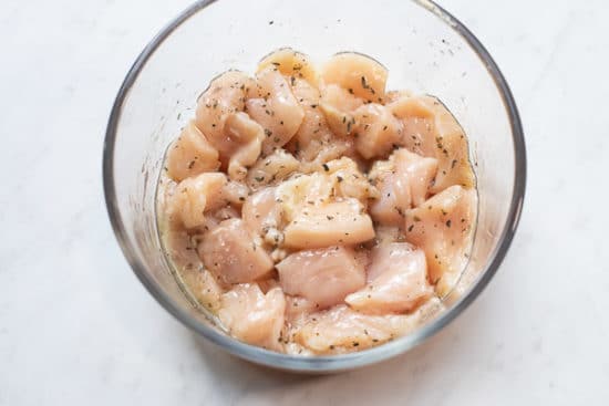 Raw chicken in microwave safe bowl