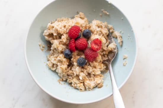 Oatmeal topped with berries and brown sugar