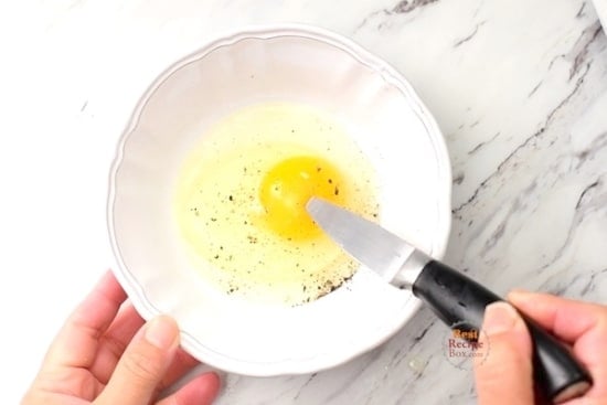 Poking egg yolk with knife tip