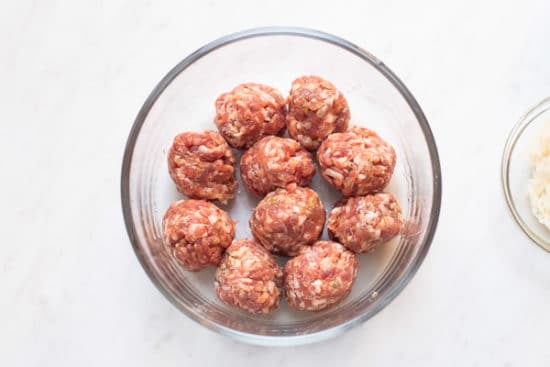 Meatballs in a single layer in microwave safe bowl
