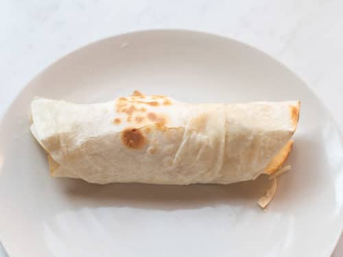 Filled tortilla rolled into a burrito