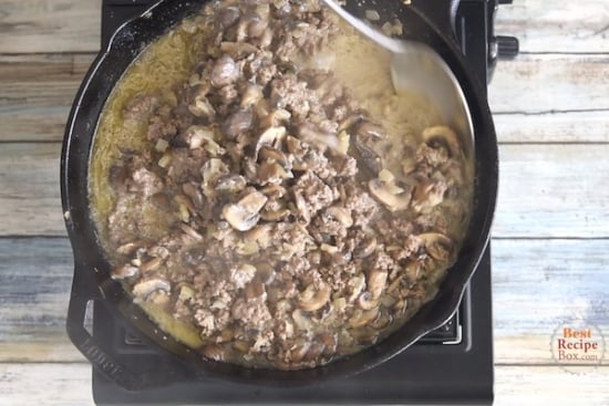 Cooked beef and mushrooms with sauce in skillet