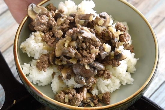Beef and mushrooms in bowl with rice