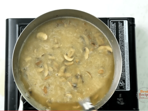 Adding broth to the mushrooms