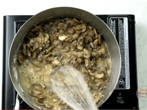 Whisking flour into the mushrooms