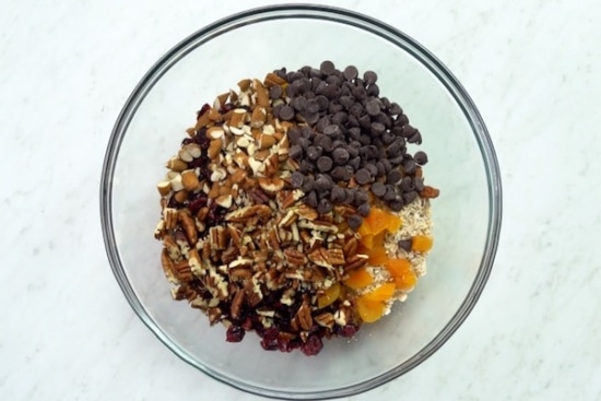 Oats, nuts, and dried fruit combined in a bowl