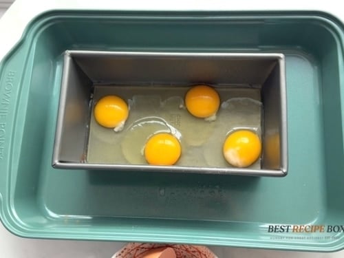 Eggs cracked into loaf pan
