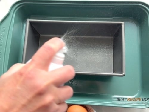 Spraying loaf pan with oil