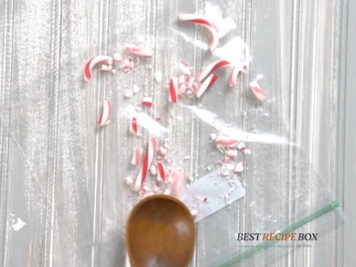 Crushing candy canes in a bag with a spoon