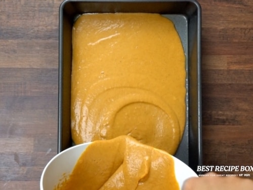 Pouring pumpkin mix in pan