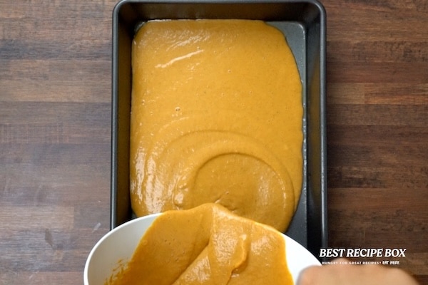 Pouring pumpkin mix in pan
