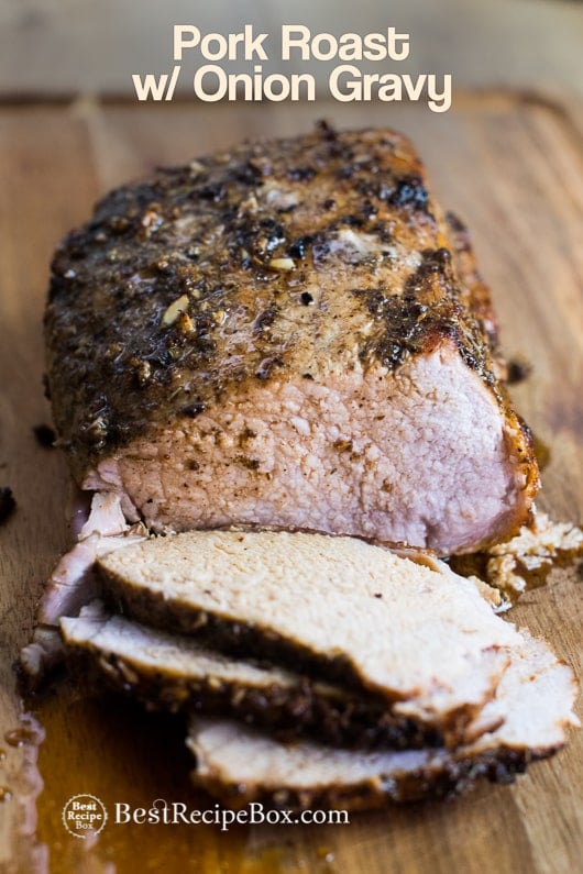 Roast Pork Recipe with Caramelized Onion Gravy on wooden cutting board