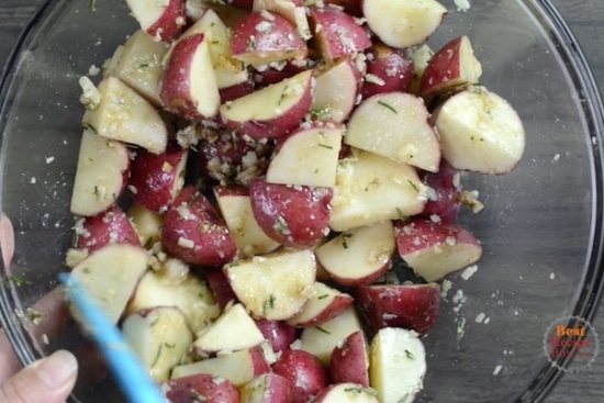 Tossing potatoes with garlic and seasonings