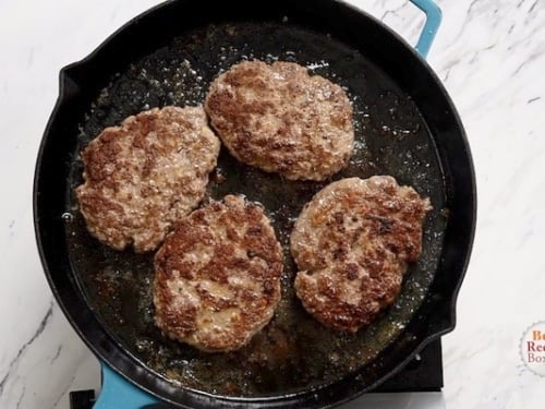 Seared beef patties in a skillet